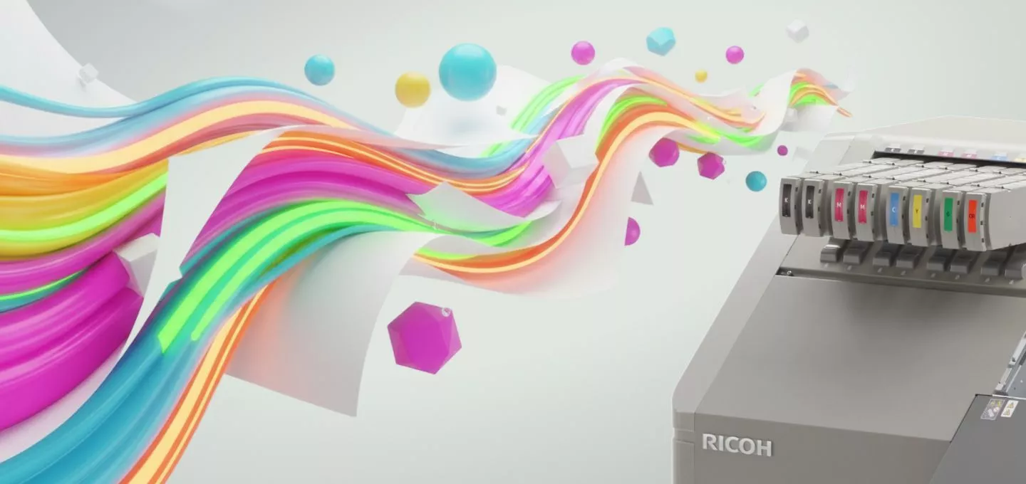 A digital illustration shows a close-up of the ink cartridge section of a Ricoh printer on the right. Colorful ribbons of paper and abstract shapes in various bright colors, including pink, orange, yellow, and blue, flow out of the printer towards the left side of the image. The scene suggests a vibrant and creative output from the machine.